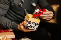 Kaboompics - Man Holding Red Toy Car above Patterned Gift Box
