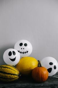 Kaboompics - Spooky Halloween Ghost Balloons and Pumpkin Still Life