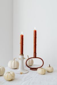 Kaboompics - Close-Up of Lit Rust-Colored Taper Candles and White Mini Pumpkins