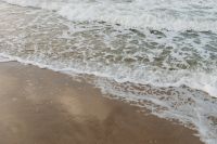 Kaboompics - Lacy Sea Foam and Shallow Wave Pattern on Wet Baltic Beach Sand