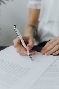 Kaboompics - Close-Up of Professional Signing a Business Agreement at Office Desk