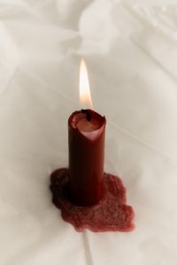 Kaboompics - Burgundy Taper Candle on White Draped Fabric