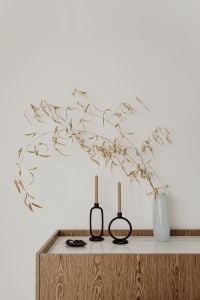 Kaboompics - Wooden Sideboard with Dried Branches and Black Candle Holders