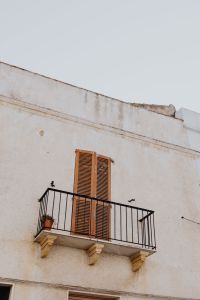 Kaboompics - Cream Historic Facade with Iron Balconies and Potted Flowers