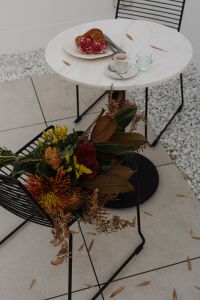 Kaboompics - Coffeehouse Table with Croissant, Espresso and Water Glass beside Autumn Bouquet