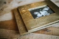 Kaboompics - Ornate Gold Picture Frame with Floral Photograph on a Rustic Wooden Table