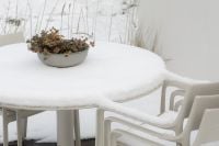 Kaboompics - Snow Covered Garden Table with Dried Floral Arrangement