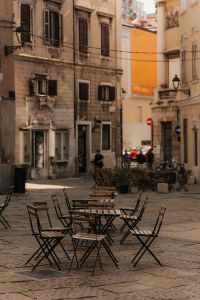 Kaboompics - Outdoor Cafe Tables on a Cobblestone Square in Trieste