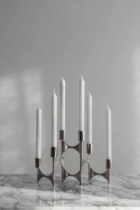 Kaboompics - Five White Taper Candles on Chrome Candelabra, Minimal Silver Decor on Marble