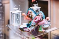 Kaboompics - Painted Ceramic Swan and Flamingo Figurines with White Lanterns