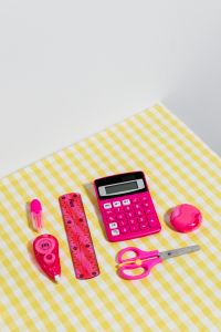 Colorful School Supplies on a Yellow Gingham Background