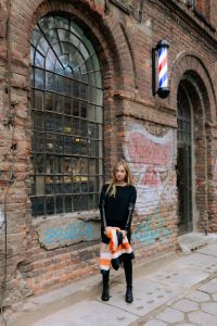 Kaboompics - Black Streetwear Portrait against a Graffiti Brick Wall beneath an Arched Factory Window