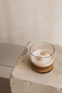 Kaboompics - Layered Glass Coffee on a Stone Plinth with Diagonal Shadows