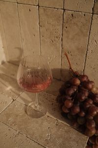 Kaboompics - Red Grapes and Wine Glass on Travertine