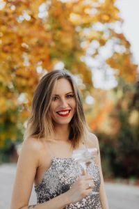 Kaboompics - Smiling Champagne Portrait with Golden Autumn Bokeh