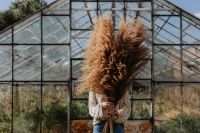 Kaboompics - Woman Turning with a Pampas Bouquet in the Glasshouse