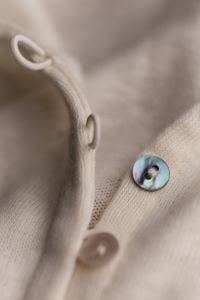 Kaboompics - Detailed Beige Knit Garment With Small Button