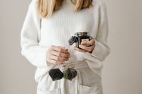 Kaboompics - Woman Holding Christmas Ornaments and a Love Candle