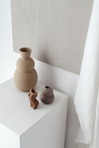 Kaboompics - Sculptural Beige Vases and Clay Object on White Plinth