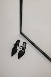 Kaboompics - Black Pointed Heels Against Ribbed Glass Wall