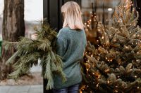 Kaboompics - The woman is holding pine branches in her hands