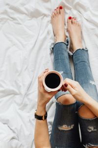 Kaboompics - Woman with coffee and flowers in bed