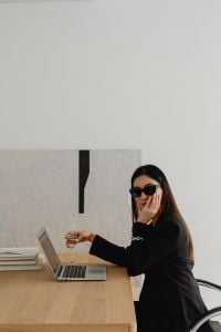 Kaboompics - Asian Businesswoman Working on a Laptop at a Wooden Desk