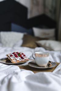 Kaboompics - Vertical Breakfast in Bed Still Life with Waffles, Coffee and White Bedding