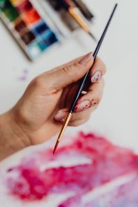 Kaboompics - A woman paints with watercolors