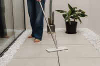 Kaboompics - Woman Wiping a Tiled Floor with a Cleaning Sponge