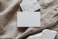 Kaboompics - Landscape Blank Business Card Mockup on Greige Linen with Marble Pieces