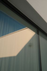 Kaboompics - Blue Glass Building Facade with Geometric Sunlight and Reflections