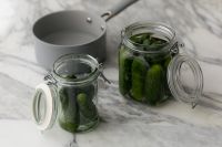 Kaboompics - Two Open Glass Jars of Cucumbers on a Marble Kitchen Counter