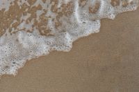 Kaboompics - Minimal Baltic Beach Sand Background with Diagonal Sea Foam and Copy Space