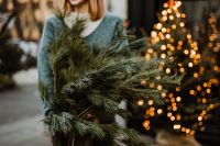 Kaboompics - The woman is holding pine branches in her hands