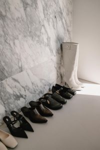 Kaboompics - Shoe Collection with White Knee-High Boots on Marble Shelf