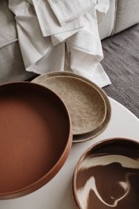 Kaboompics - Ceramic Plates on White Coffee Table with Linen – Fujifilm X100VI
