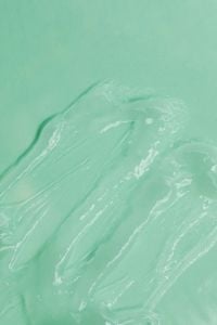 Kaboompics - Flowing Transparent Gel Texture Close-Up on Soft Green Background