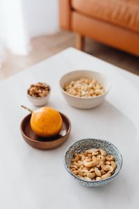 Kaboompics - Cashews, Walnuts and Passion Fruit on a Coffee Table for Cozy Snack Lifestyle