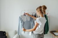 Kaboompics - Teenage Girl Choosing Clothes from a Bedroom Rack, Casual Wardrobe and Youth Fashion