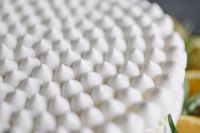 Kaboompics - Meringue Cake with whipped cream and oranges