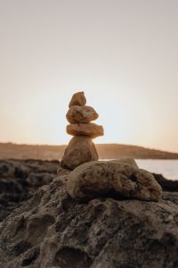Kaboompics - Stacked Stones on a Rocky Shore at Sunset