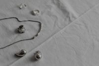 Kaboompics - Silver Jewelry Arranged on White Tablecloth