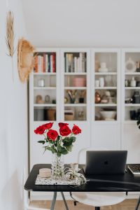 Kaboompics - Vertical Home Office with Red Rose Bouquet, Laptop and Glass Vase
