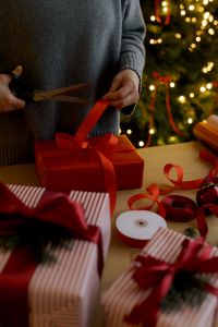 Kaboompics - Tying Red Ribbon Bow on Christmas Present