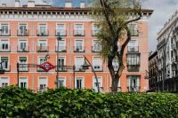 Kaboompics - Coral Apartment Facade and Tirso de Molina Metro Sign in Madrid