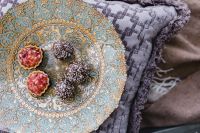 Kaboompics - Overhead of Pomegranate Tarts and Chocolate Truffles on an Ornate Plate