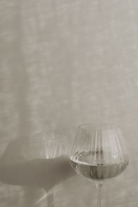 Kaboompics - Ribbed Glass of Water and Soft Shadows on a Beige Background