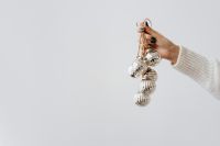 Kaboompics - Silver Christmas Baubles Hanging from a Hand with Copy Space