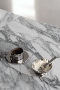Kaboompics - Chrome Espresso Cup and Whipped Cream Dessert in Silver Bowl on Veined Marble, Minimal Food Still Life